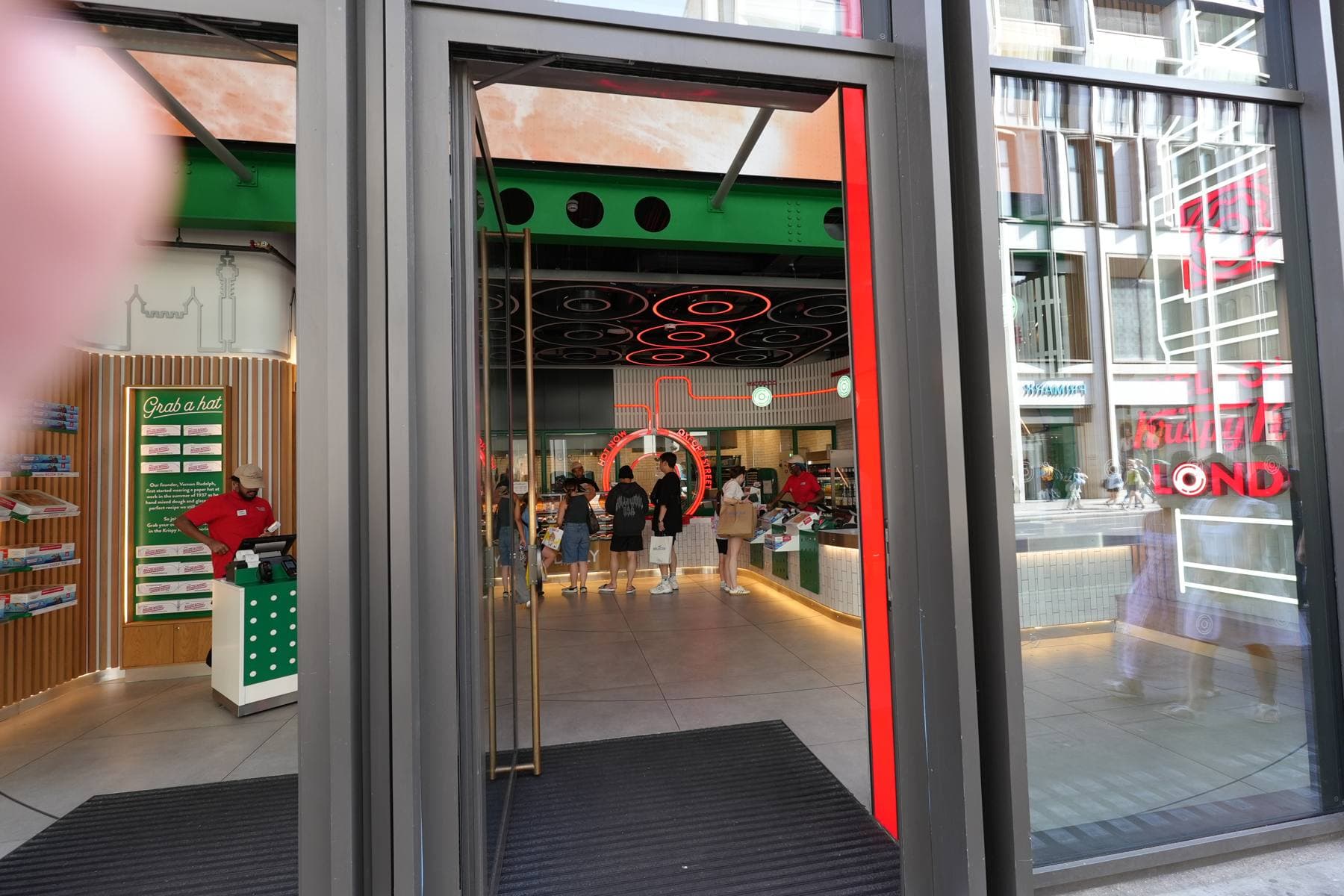 Entrée vitrée d’une boutique, vue depuis la rue